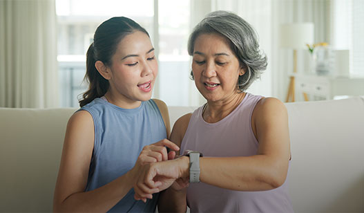 two women looking at a smart watch 