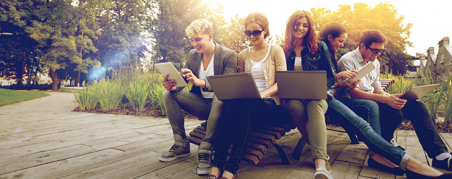 Students using laptops on campus
