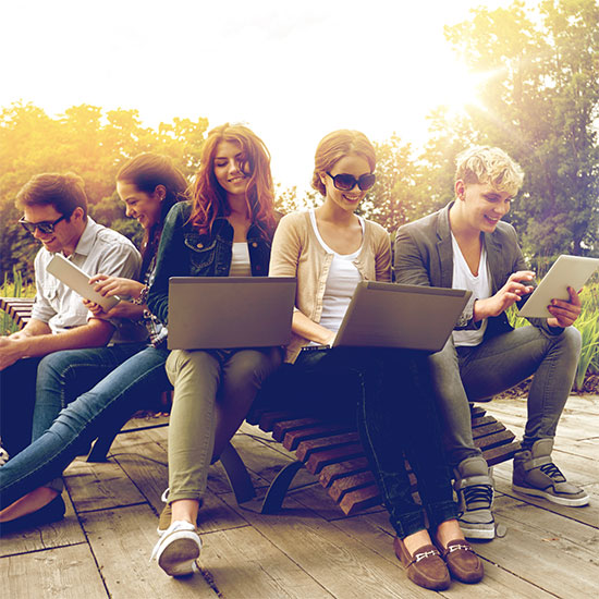 Students using laptops on campus