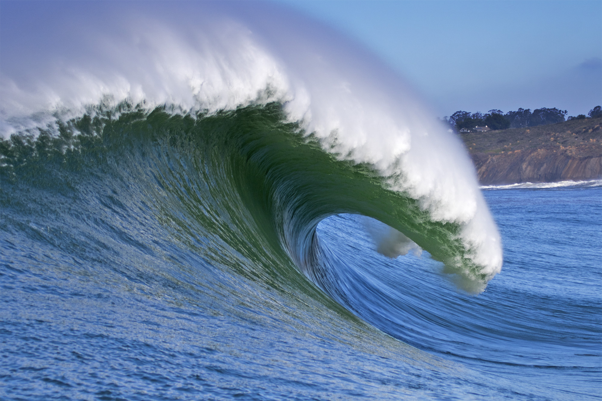 Side shot down a large wave