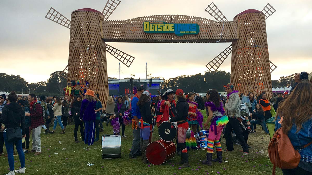 Large wooden gate with large crowd gathered for a festival