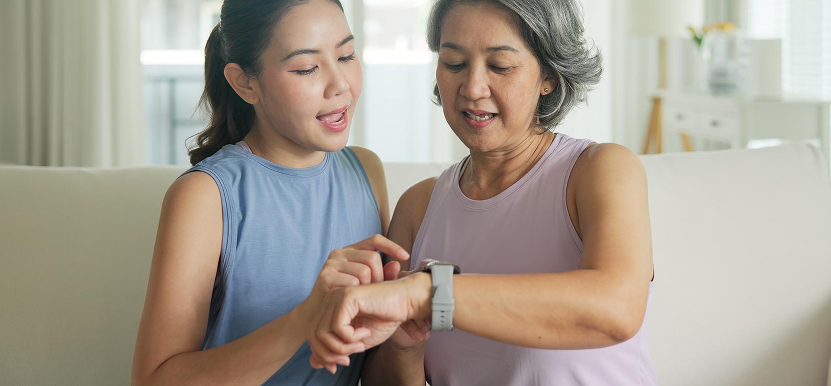 two women looking at a smart watch 
